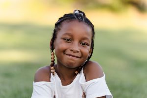 Portrait of a young girl smiling outside